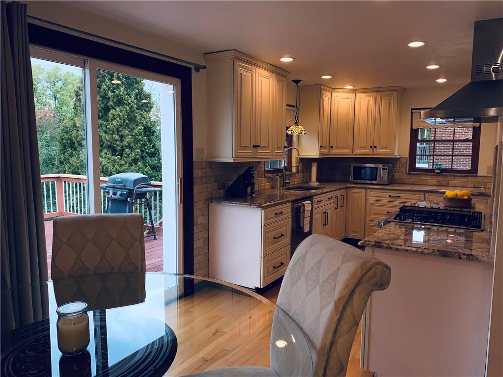 4776 Rolling Hills Road Pittsburgh, PA 15236 - Photo 9 of 25 The incredibly remodeled kitchen from 2015 features solid maple cabinets with soft close doors/drawers,travertine backsplash, granite counters and premium appliances.