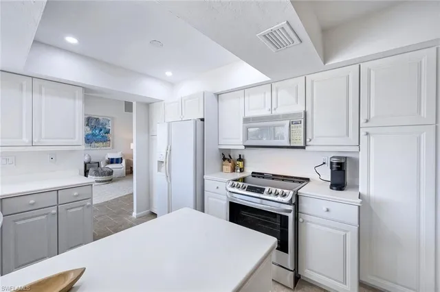 a kitchen with cabinets and appliances