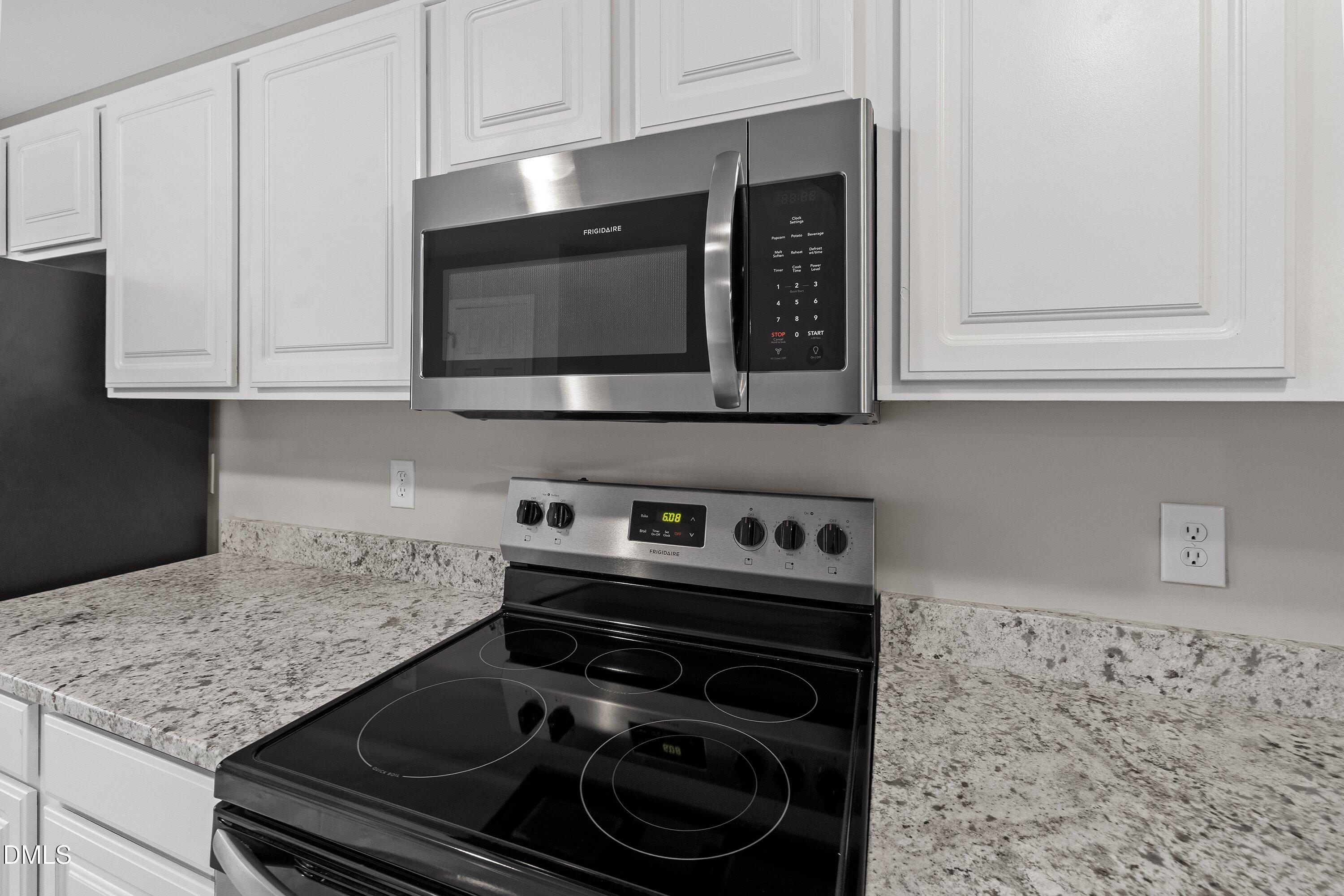 140 Melksham Road Wake Forest, NC 27587 - Photo 18 of 34 a kitchen with a stove and a microwave