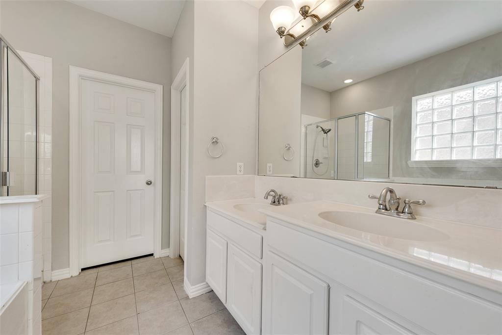 2716 Raspberry Court Plano, TX 75074 - Photo 11 of 20 Bathroom with vanity, a shower with shower door, and tile patterned flooring
