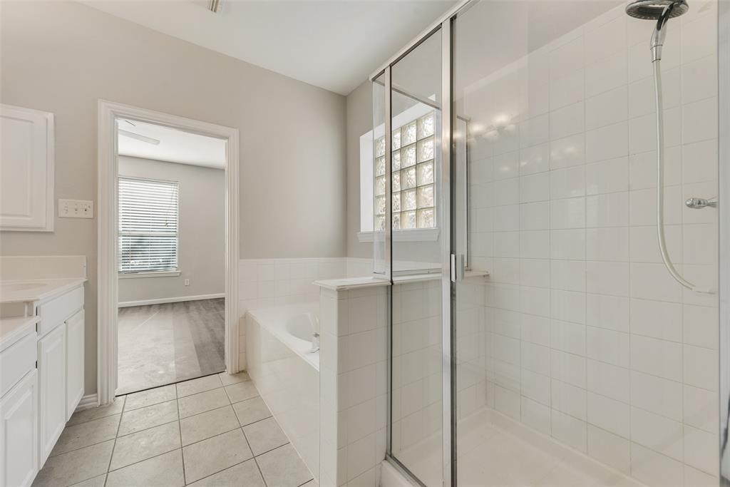 2716 Raspberry Court Plano, TX 75074 - Photo 12 of 20 Bathroom featuring vanity, separate shower and tub, and tile patterned floors
