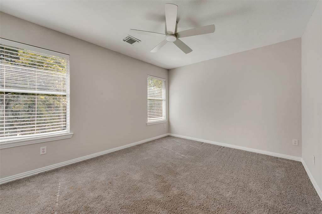 2716 Raspberry Court Plano, TX 75074 - Photo 15 of 20 Carpeted empty room featuring ceiling fan