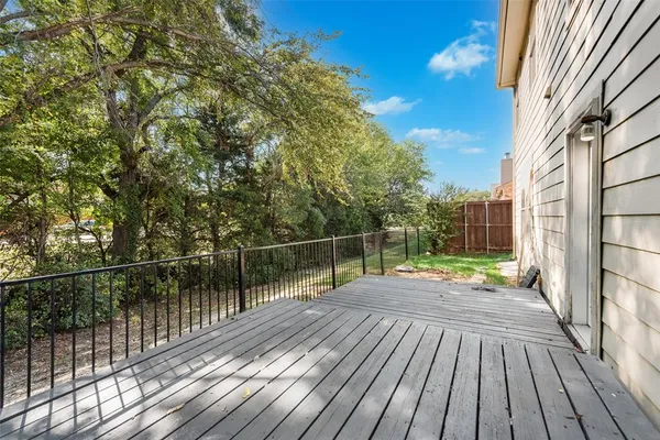 a view of balcony with wooden floor and fence