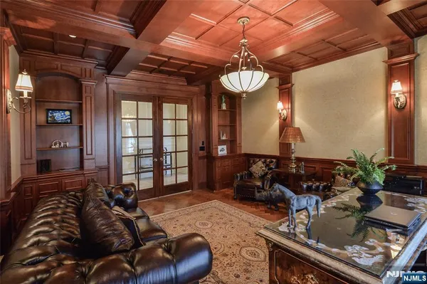 a living room with furniture a chandelier and a window