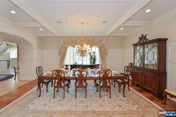 a view of a a dining room with furniture window and wooden floor