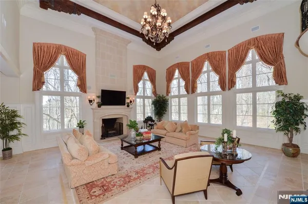 a living room with furniture a fireplace and a large window