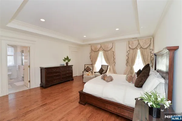 a bedroom with furniture and wooden floor