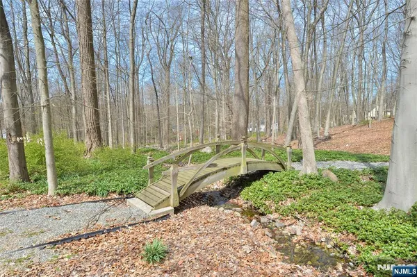 a garden with trees in front of it