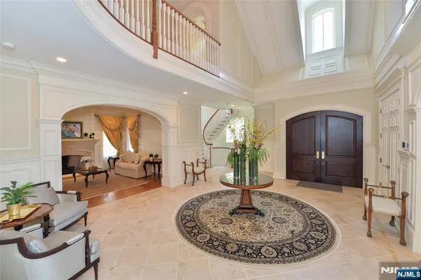 a living room with furniture a fireplace and potted plants