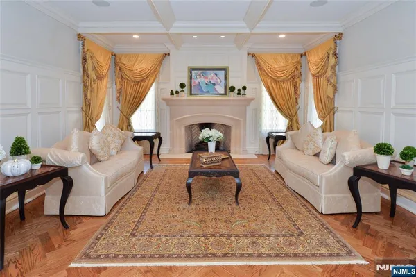 a living room with furniture a rug and a fireplace