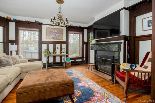 a living room with furniture a flat screen tv and a fireplace