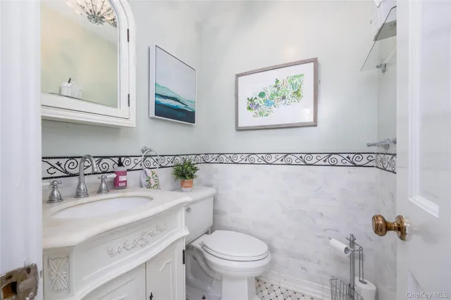 a bathroom with a sink toilet and a mirror