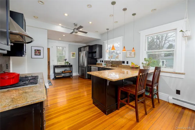 a kitchen with a table chairs and microwave