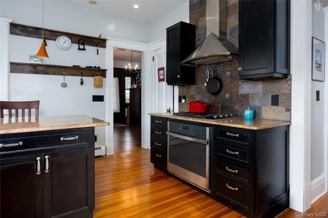 a kitchen with stainless steel appliances granite countertop a stove and cabinets