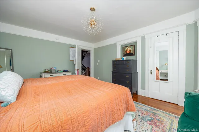 a spacious bedroom with a bed and a dresser