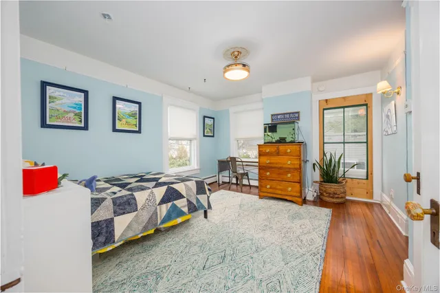 a bedroom with furniture and a large window