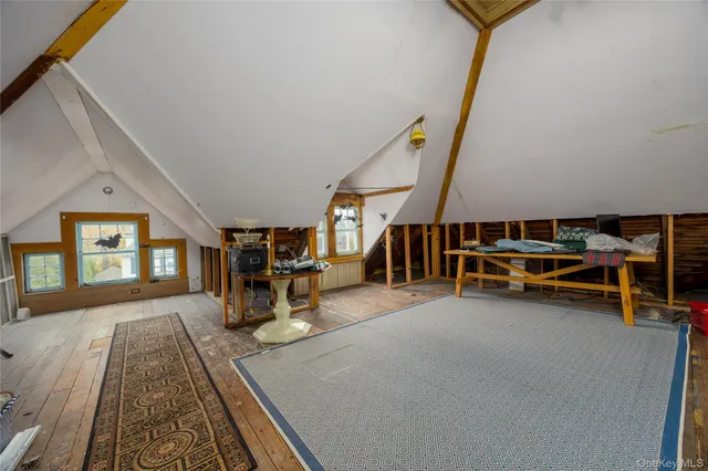 a view of a livingroom with furniture and staircase