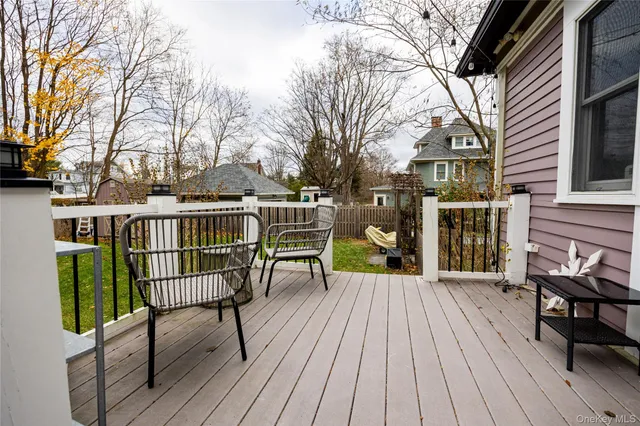 a view of a chairs and table on the wooden deck