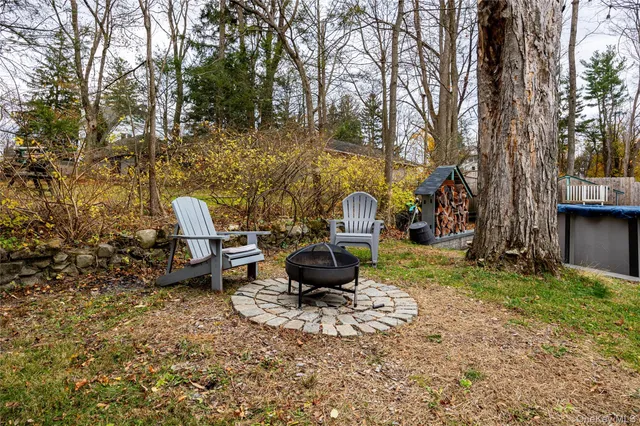 a backyard of a house with table and chairs