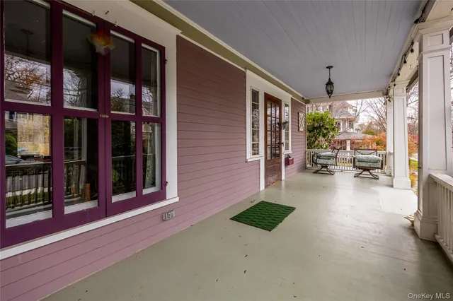 a view of a porch with chairs and backyard