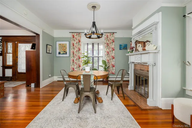 a dining room with furniture a chandelier and wooden floor