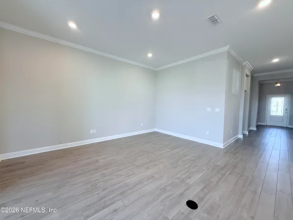 a view of a room with wooden floor