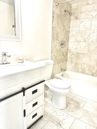 a bathroom with a toilet a sink and a bathtub