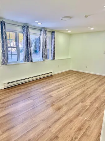a view of a room with wooden floor and window