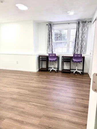 a room with a table chair and a window