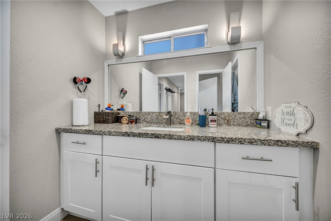 5882 Rio Tinto Way Las Vegas, NV 89110 - Photo 19 of 56 Well-lit vanity features ample counter space and a large mirror.