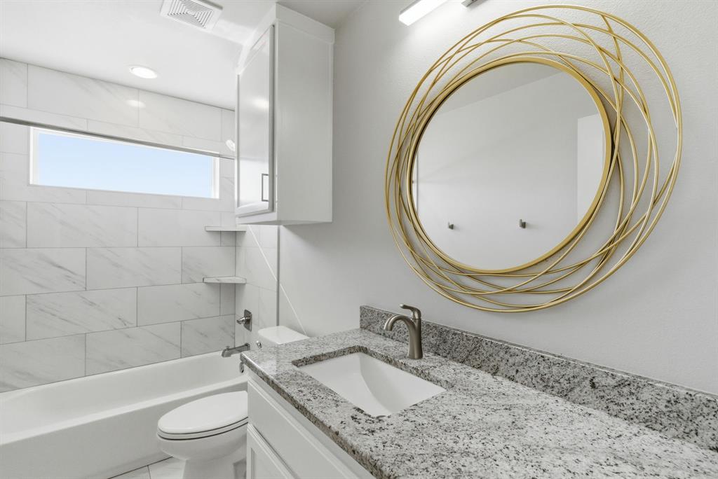 4600 Old Brock Road Weatherford, TX 76087 - Photo 29 of 37 Bathroom featuring a white vanity with a speckled countertop, undermount sink, and brushed nickel faucet
