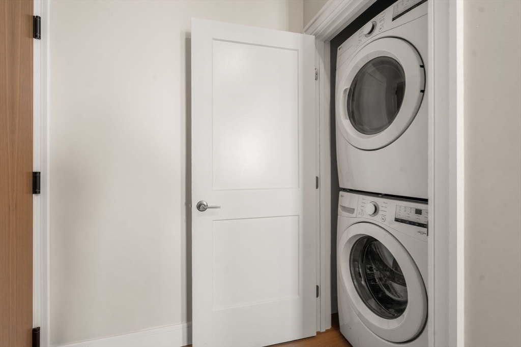 40 Soldiers Field Place, Unit 301 Boston, MA 02135 - Photo 11 of 13 a utility room with dryer and washer