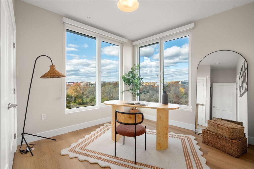 40 Soldiers Field Place, Unit 301 Boston, MA 02135 - Photo 8 of 13 a living room with furniture and a window