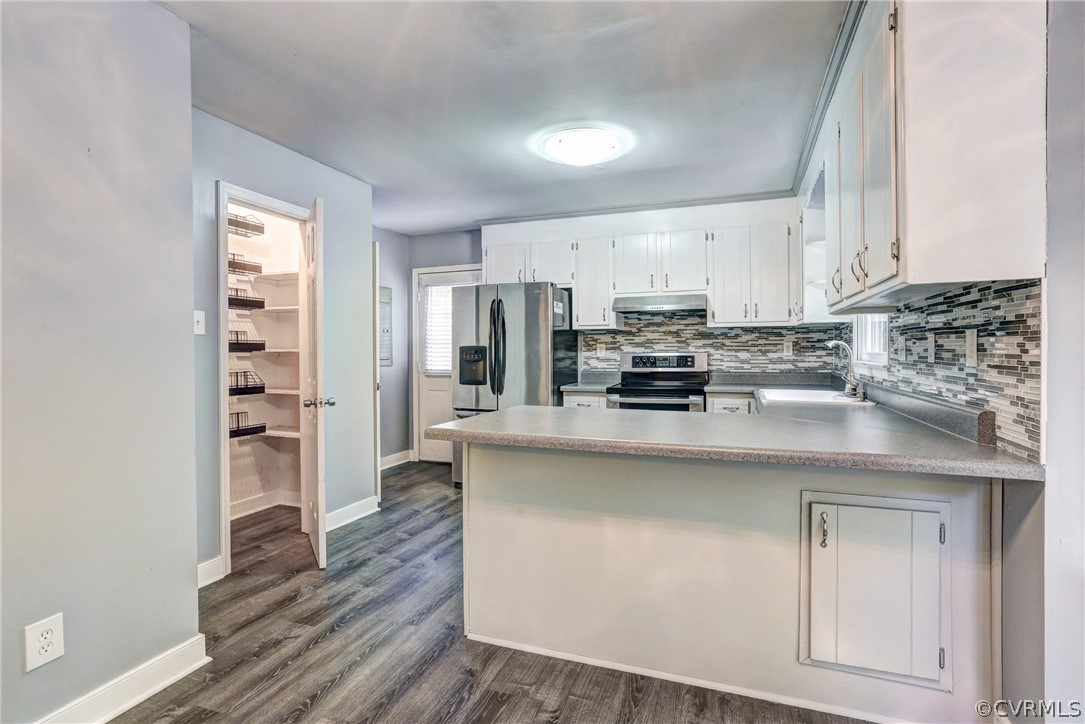 7519 Barkbridge Road Chesterfield, VA 23832 - Photo 11 of 40 a kitchen with stainless steel appliances granite countertop a stove a sink and white cabinets with wooden floor