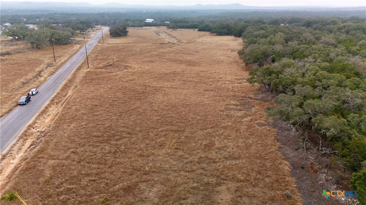 Lot 15 Clearwater Canyon Road Bandera, TX 78003 - Photo 3 of 9 a view of a dry yard with wooden fence