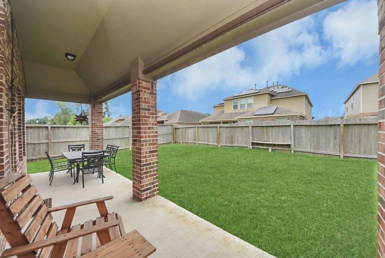 24503 Eucalyptus Way Spring, TX 77373 - Photo 24 of 27 a view of a chairs and table in patio next to a yard
