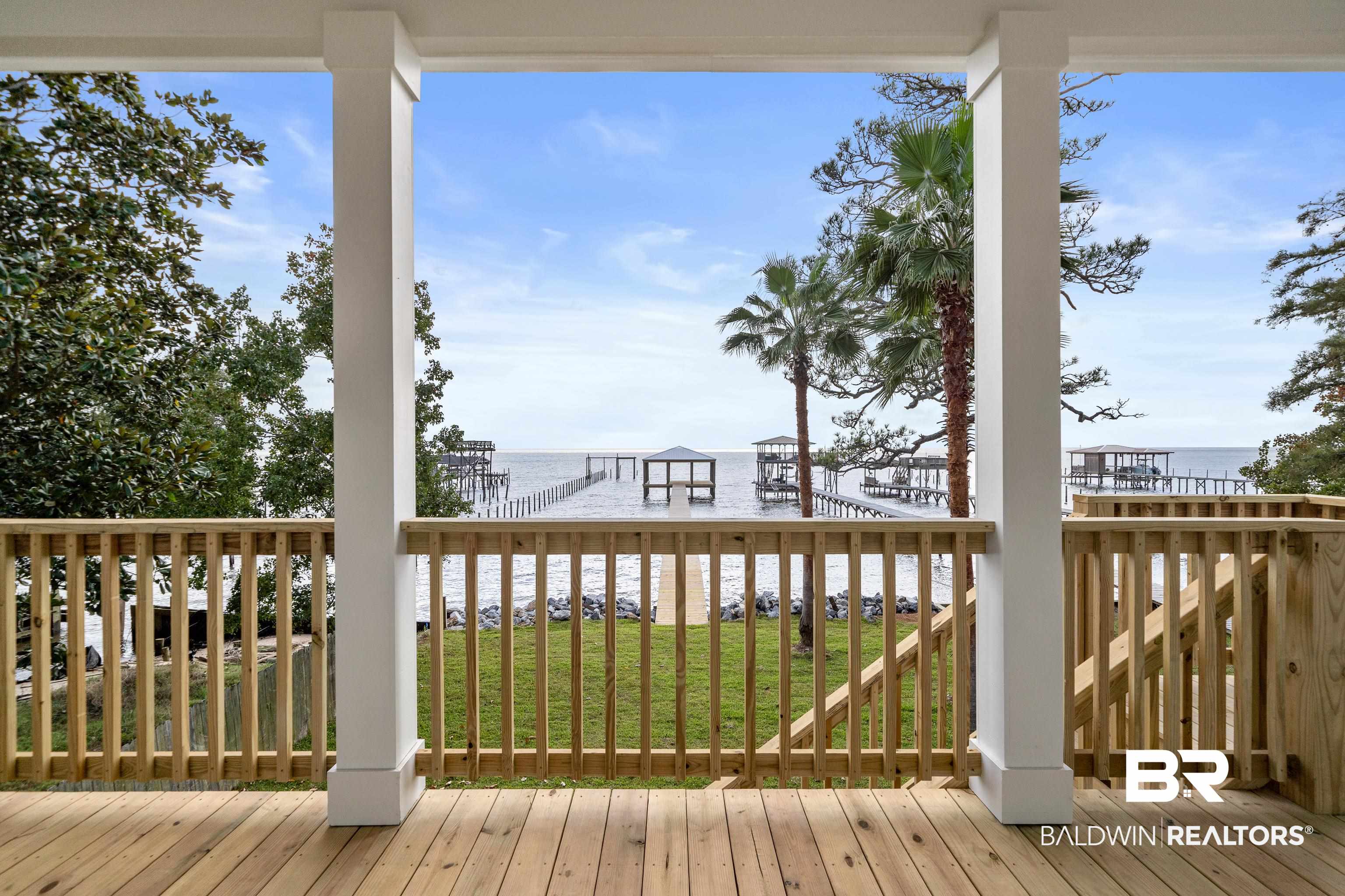 12453 County Road 1 Fairhope, AL 36532 - Photo 25 of 33 Wooden terrace featuring a lawn and a water view