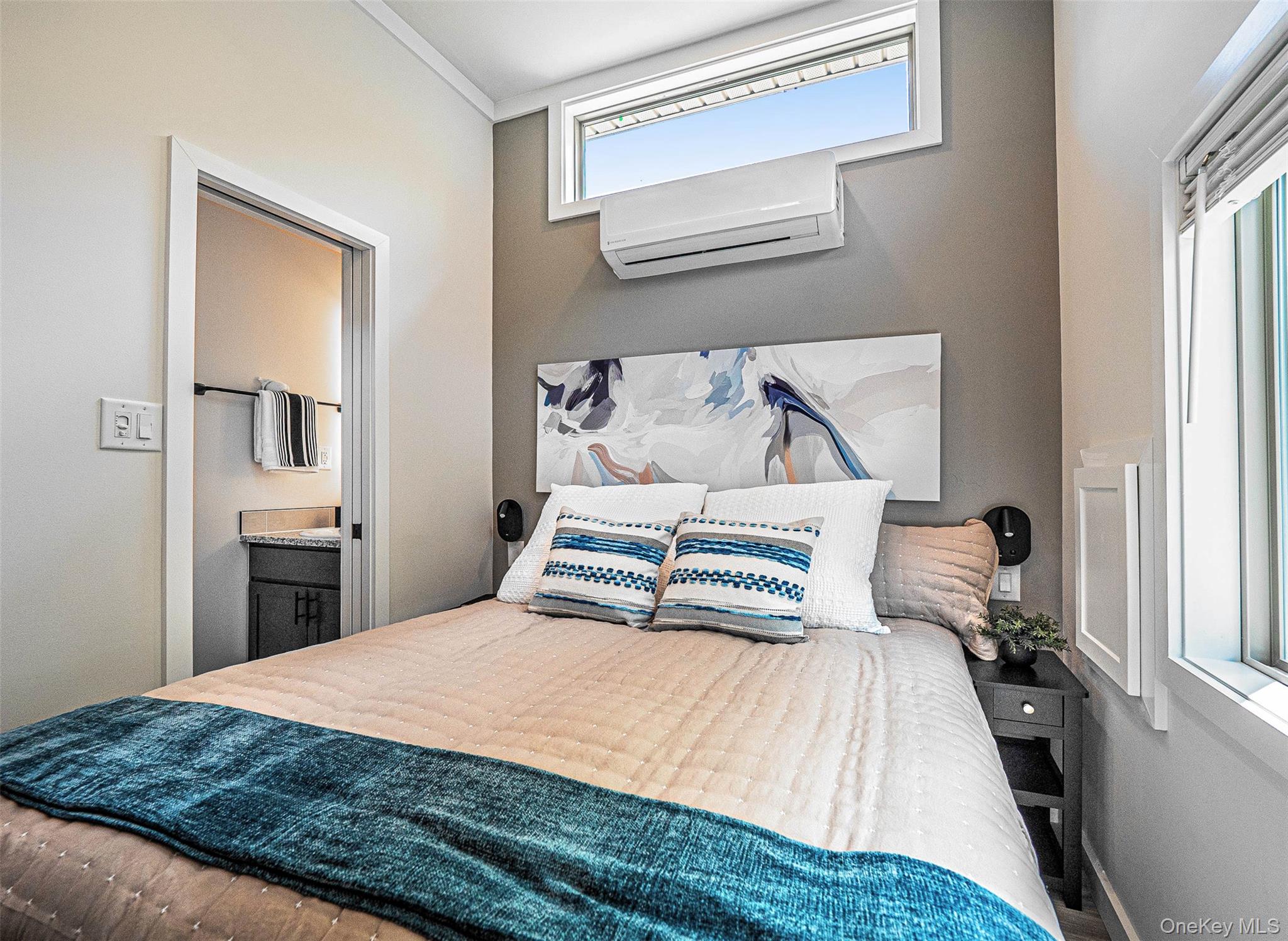 197 Wheeler Road, Unit 101 Florida, NY 10921 - Photo 12 of 41 Primary bedroom with a wall unit AC and ensuite bath