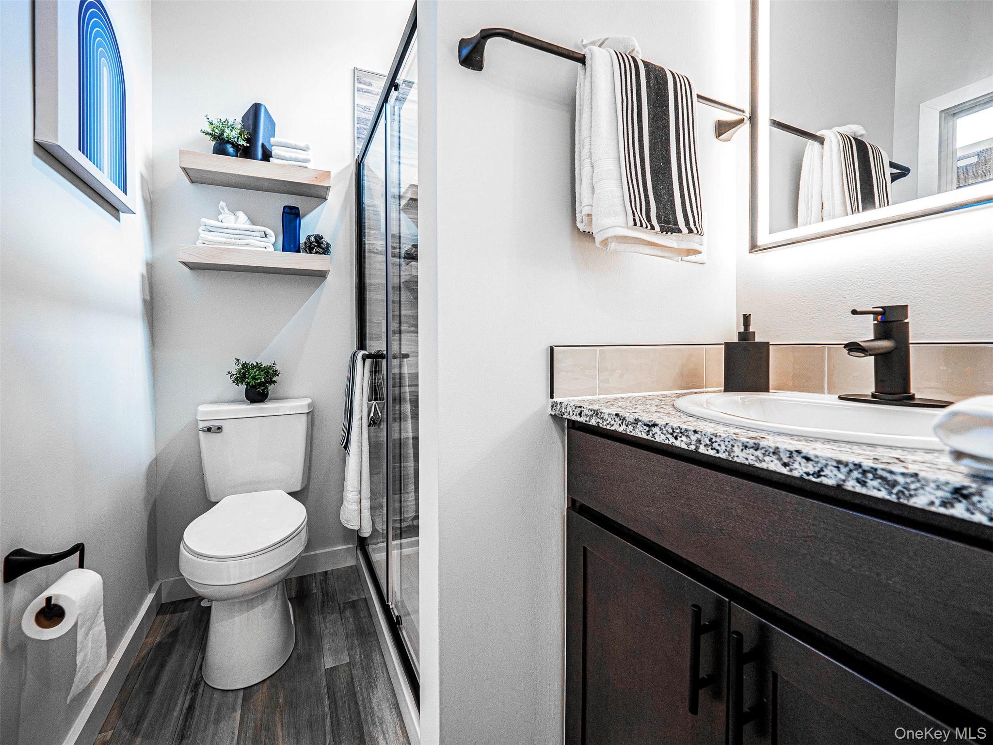 197 Wheeler Road, Unit 101 Florida, NY 10921 - Photo 16 of 41 Full bathroom with vanity, a stall shower, and dark wood-type flooring