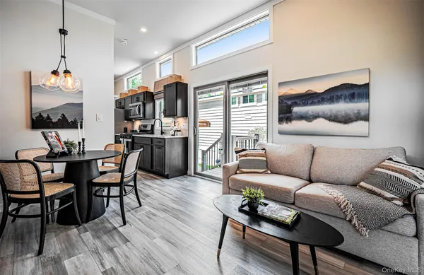 a living room with furniture a flat screen tv and wooden floor