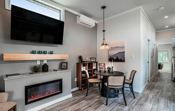 a living room with furniture a flat screen tv and a fireplace