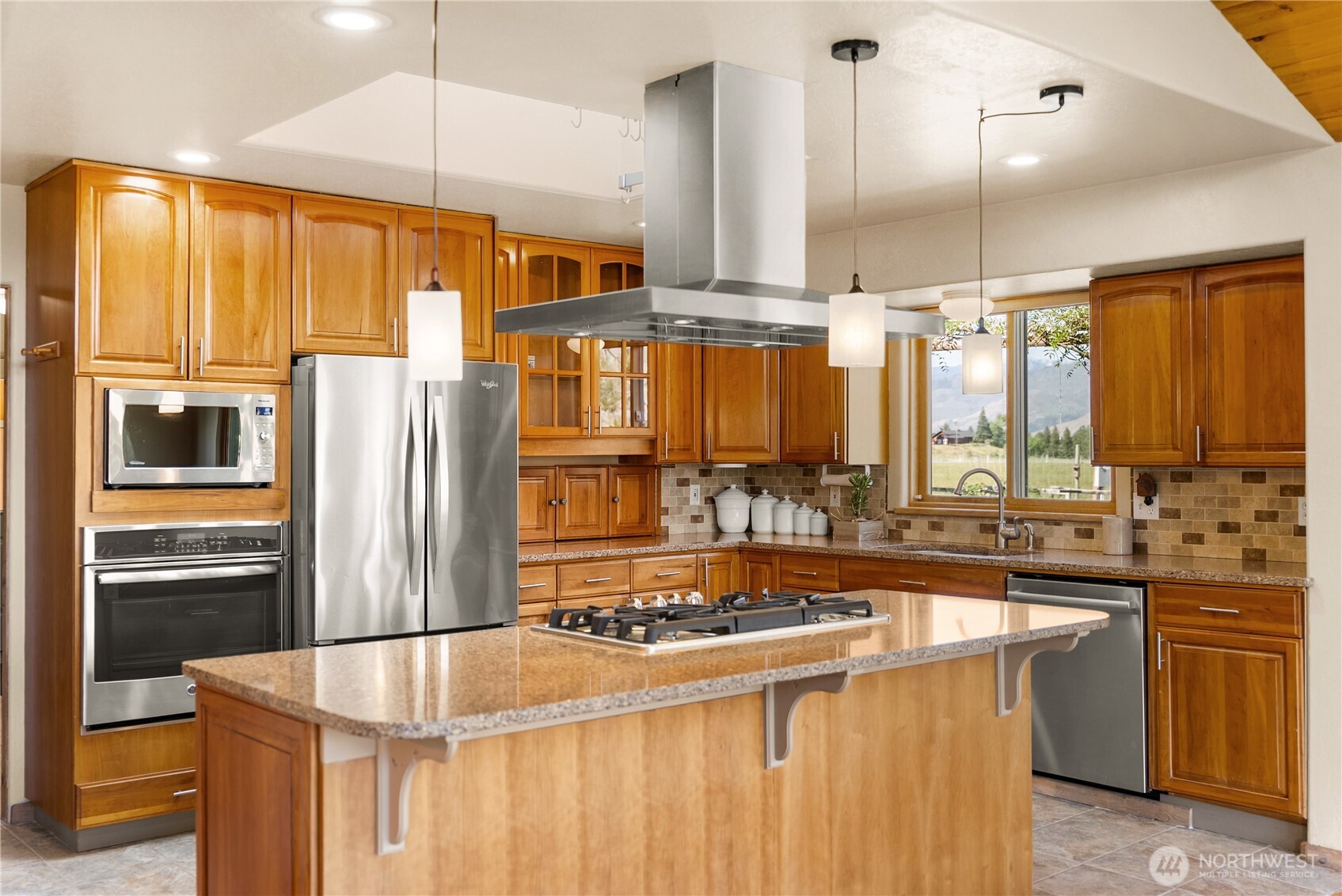 2621 Highway 153 Twisp, WA 98856 - Photo 8 of 40 a kitchen with stainless steel appliances a sink and a refrigerator