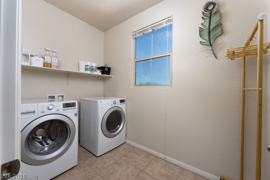 3069 Scenic Rhyme Avenue Henderson, NV 89044 - Photo 10 of 29 A dedicated laundry room — not a closet — with full-size front-load washer and dryer, a built-in supply shelf, and a window for ventilation and natural light. The kind of practical feature that quietly improves daily life.