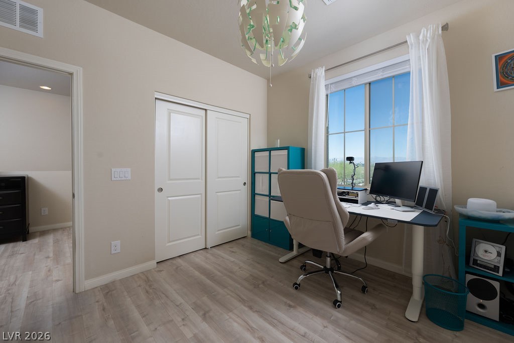 3069 Scenic Rhyme Avenue Henderson, NV 89044 - Photo 29 of 29 Currently a home office, this third bedroom has a large window with open mountain views, a full sliding-door closet, and LVP flooring. Use it as a third bedroom, a kids' homework room, or a dedicated workspace — the floor plan gives you the option.