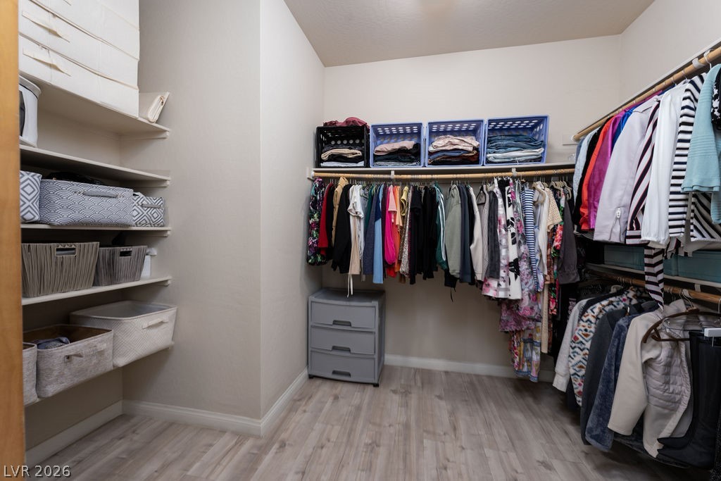 3069 Scenic Rhyme Avenue Henderson, NV 89044 - Photo 14 of 29 A true walk-in with double hanging rods, open shelving on three walls, and real floor space to move around. For anyone upgrading from an apartment or a starter home with reach-in closets, this is a tangible, daily-use upgrade.