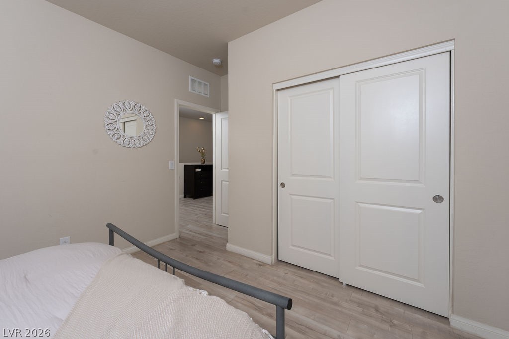 3069 Scenic Rhyme Avenue Henderson, NV 89044 - Photo 17 of 29 A well-proportioned secondary bedroom with LVP flooring, a sliding-door closet, and a window for natural light. Ready for a kid's room, a guest room, or whatever the next chapter requires.