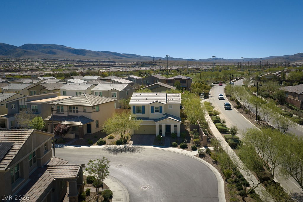 3069 Scenic Rhyme Avenue Henderson, NV 89044 - Photo 2 of 29 Situated on a low-traffic cul-de-sac with the Spring Mountains stretching across the horizon — the aerial view shows exactly why this lot stands out. Wide open skies, manicured desert landscaping throughout, and walking distance to Inspirada's park and sports complex.