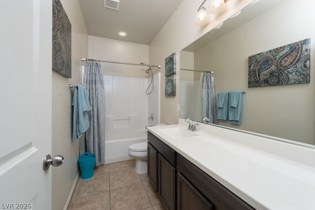 3069 Scenic Rhyme Avenue Henderson, NV 89044 - Photo 18 of 29
The upstairs hall bath serves the secondary bedrooms with a full tub and shower combo, a dark wood vanity with a wide countertop, and chrome fixtures throughout. Clean, functional, and styled to feel like more than a spare bath.