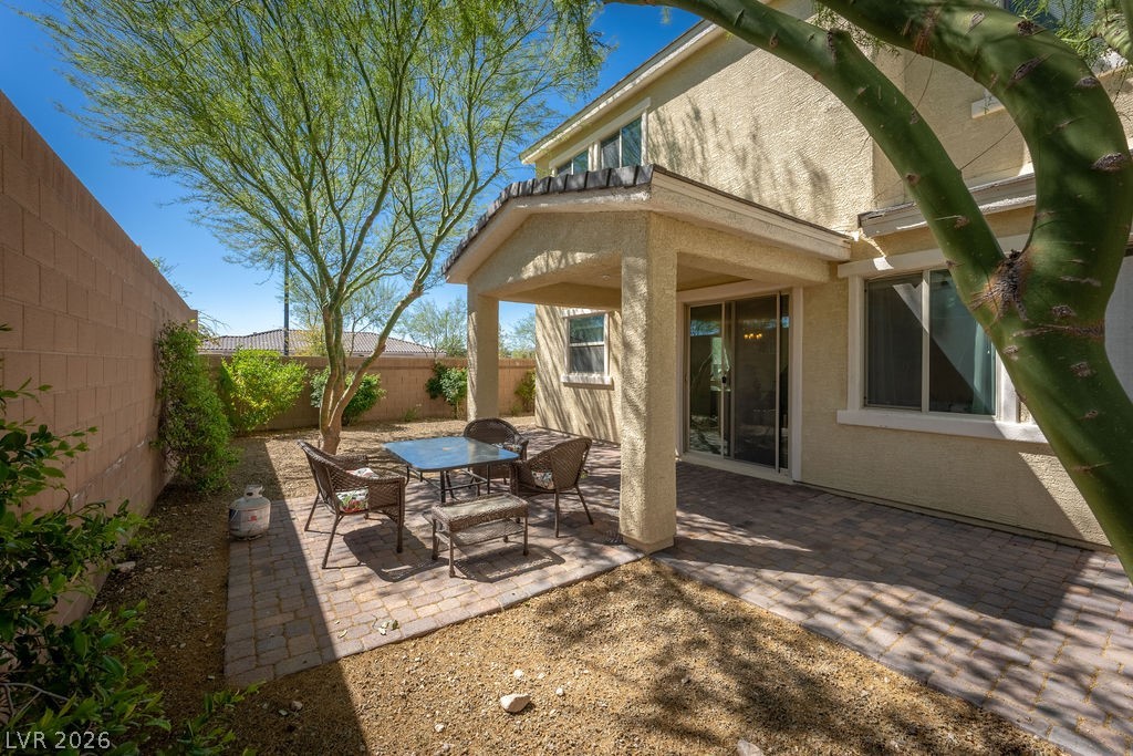 3069 Scenic Rhyme Avenue Henderson, NV 89044 - Photo 19 of 29 The fully walled backyard gives you privacy, a mature shade tree, a covered patio, and room to breathe — without the maintenance burden of grass. The paver patio extends your living space from the moment the slider opens.