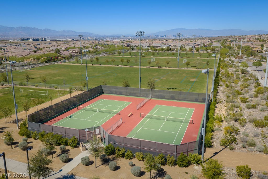 3069 Scenic Rhyme Avenue Henderson, NV 89044 - Photo 26 of 29 Inspirada's community courts include both tennis and pickleball — two of the fastest-growing recreational sports in the valley — with lighting for evening play and the Las Vegas skyline visible on the horizon. Whether it's a weekend match or a weeknight game, the courts are steps from your front door.